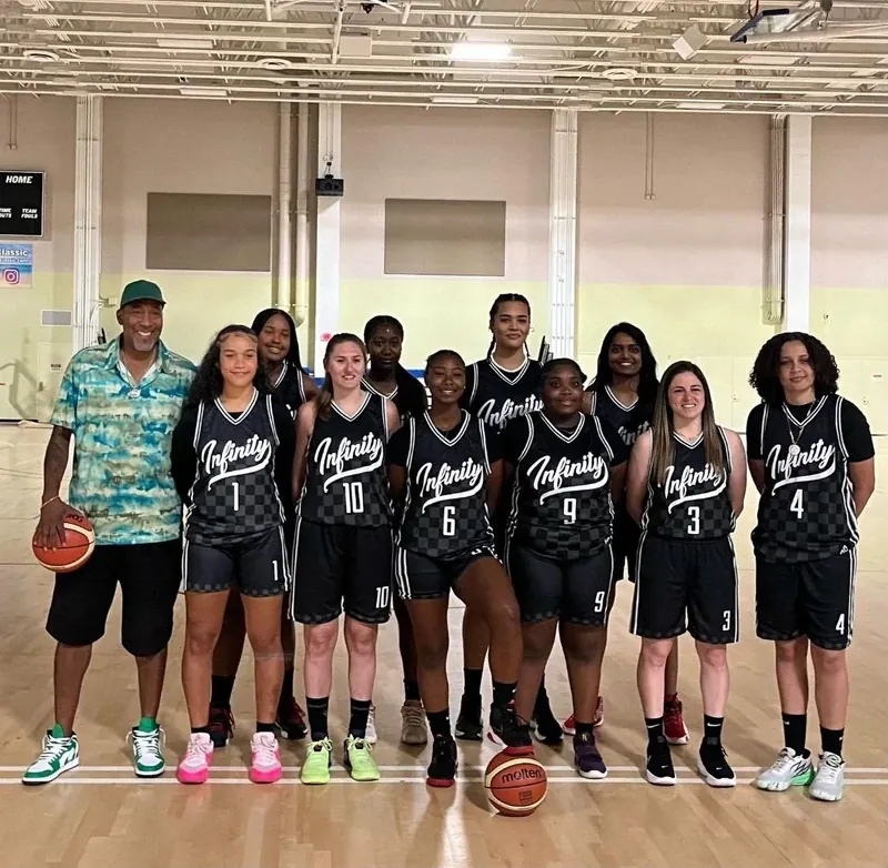 Women's basketball team lined up with head coach Cory McGee